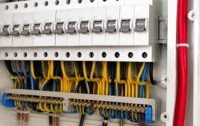 Technician testing an electrical panel